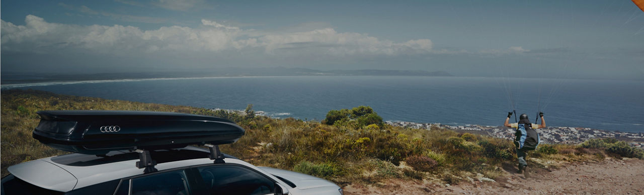 An Audi vehicle parked on a coastal hillside